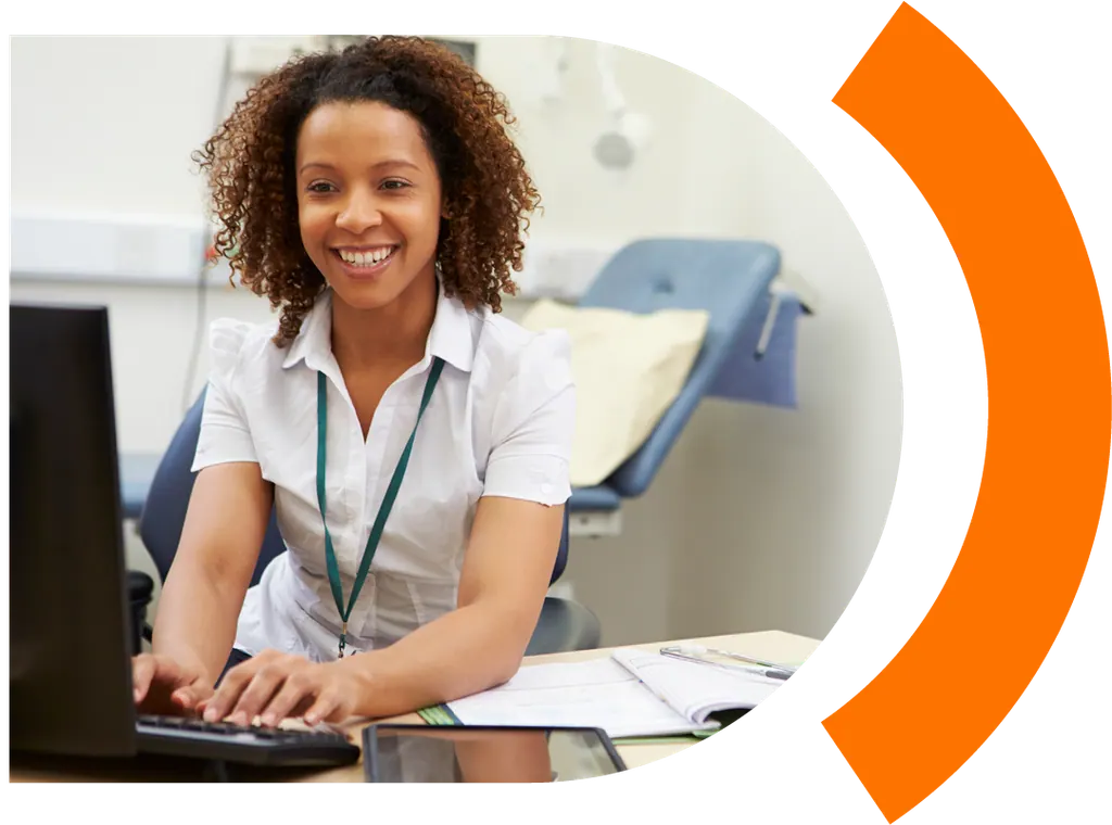 A health information management professional at a clinic workstation
